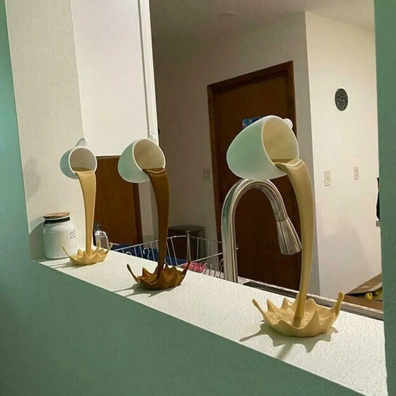 Escultura de taza de café flotante con decoración de derrames y vertidos