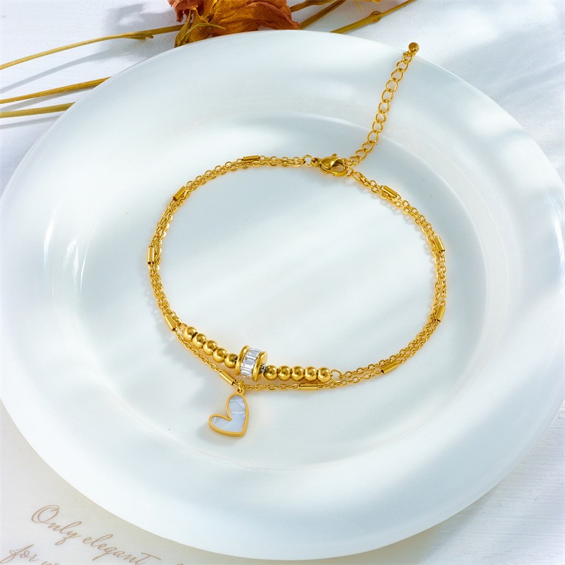 Tobillera de doble cadena con latido de corazón dorado