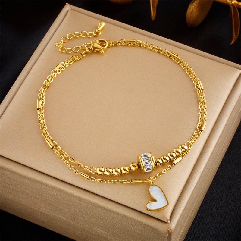 Tobillera de doble cadena con latido de corazón dorado