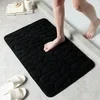 Alfombra de baño con relieve de adoquines