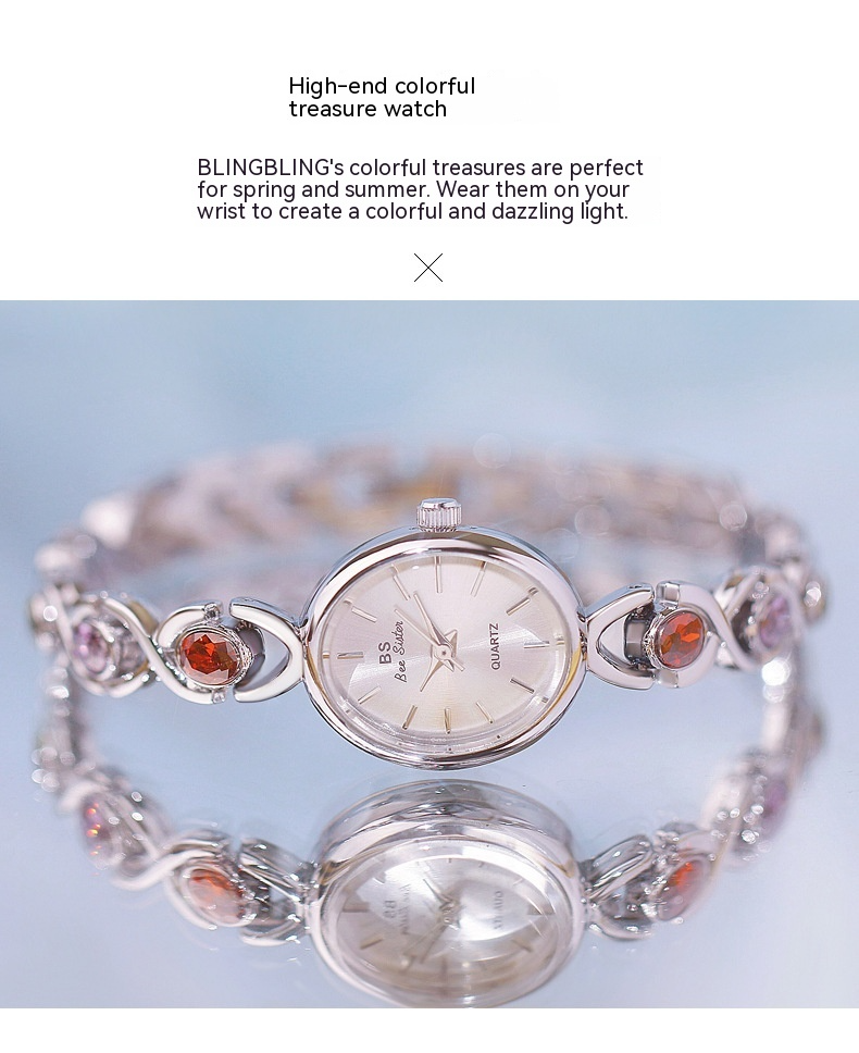 Reloj de lujo de estilo antiguo con gemas ovaladas de colores y luz arcoíris