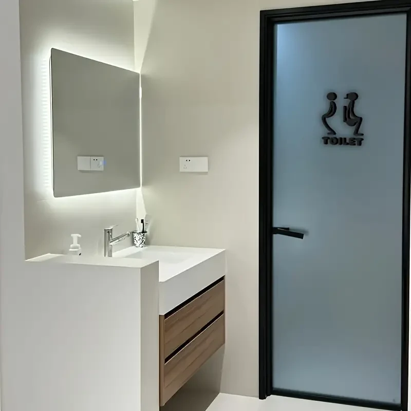 Letrero para puerta de baño unisex de acrílico 3D con diseño elegante en negro