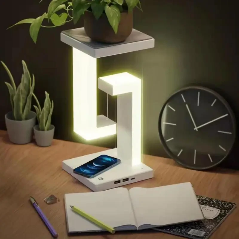 Lámpara de mesa LED plegable con suspensión antigravedad, carga inalámbrica, brazo ajustable y moderna iluminación decorativa para dormitorio y sala de estar.