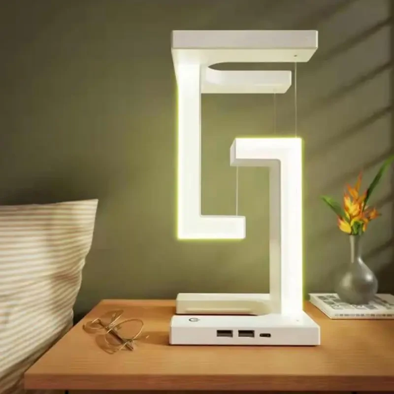Lámpara de mesa LED plegable con suspensión antigravedad, carga inalámbrica, brazo ajustable y moderna iluminación decorativa para dormitorio y sala de estar.