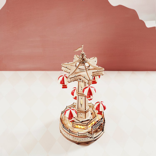 Create a magical amusement park with the Robotime ROKR Parachute Tower DIY music box. This 3D wooden puzzle features a moving parachute tower and plays a beautiful melody. Perfect as a birthday gift or Christmas present for kids and puzzle enthusiasts.
