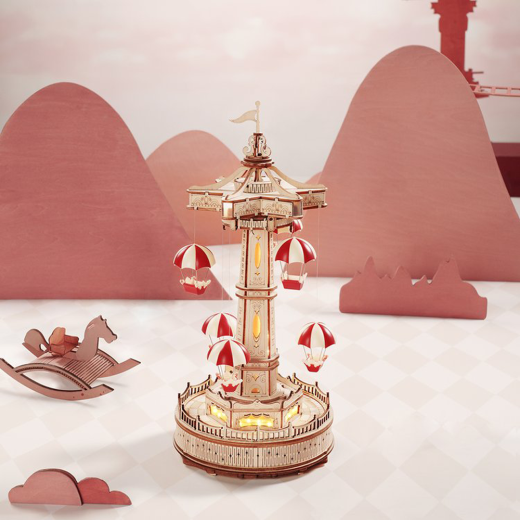 Create a magical amusement park with the Robotime ROKR Parachute Tower DIY music box. This 3D wooden puzzle features a moving parachute tower and plays a beautiful melody. Perfect as a birthday gift or Christmas present for kids and puzzle enthusiasts.