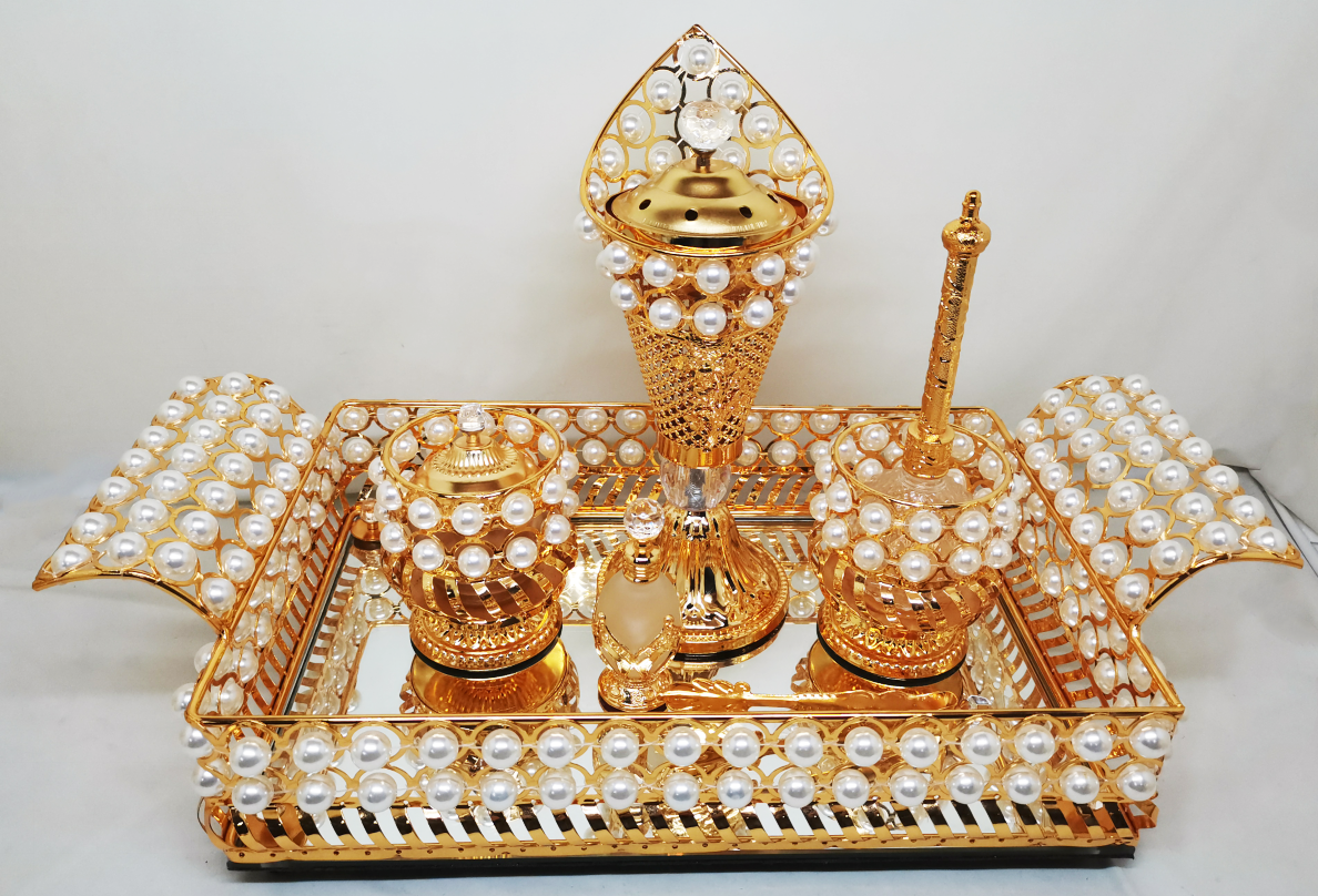 Juego de tocador con diseño dorado: candelabro, joyero, frasco de perfume y bandeja con espejo