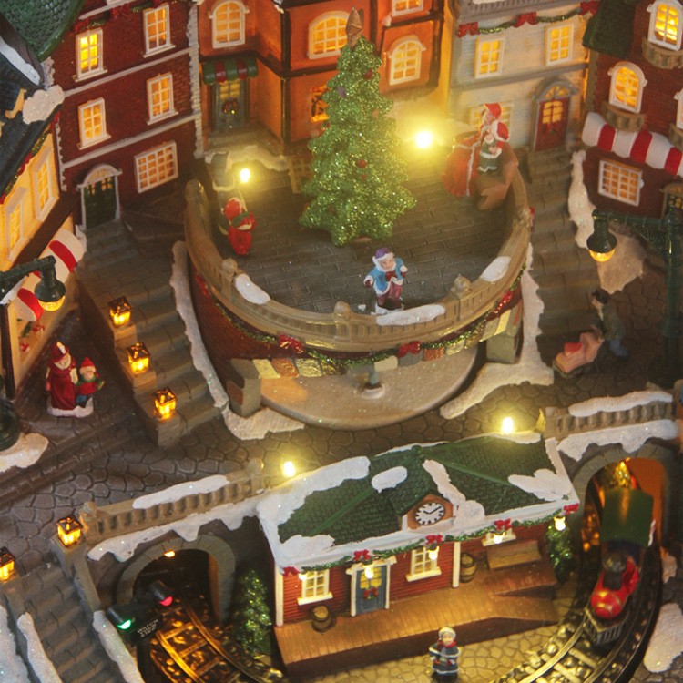 Gran casa musical LED luminosa con tren giratorio y adornos navideños giratorios.
