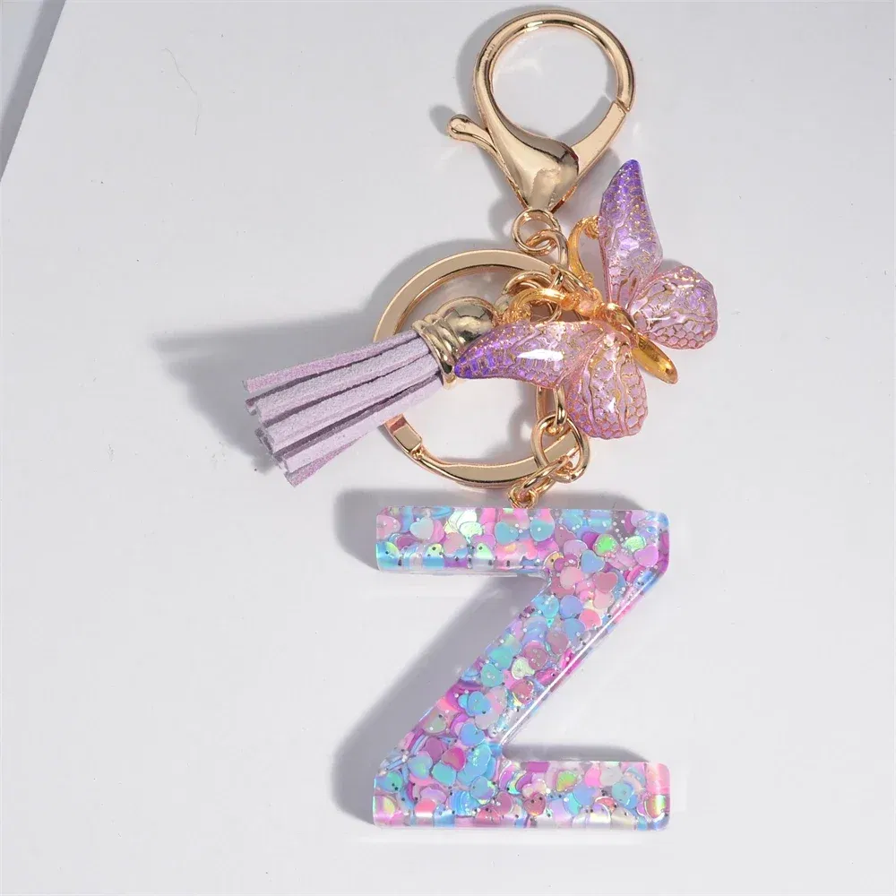 Color: Dark Brown - Fashion Tassel Butterfly 26Letter Keychain Colorful Love Heart Filled Resin Alphabet Keyring Women Girls Car Bag Phone Pendant