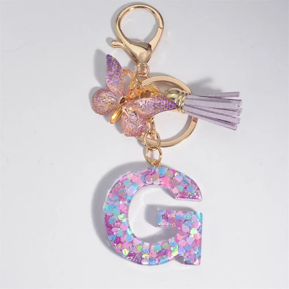 Color: Yellow - Fashion Tassel Butterfly 26Letter Keychain Colorful Love Heart Filled Resin Alphabet Keyring Women Girls Car Bag Phone Pendant
