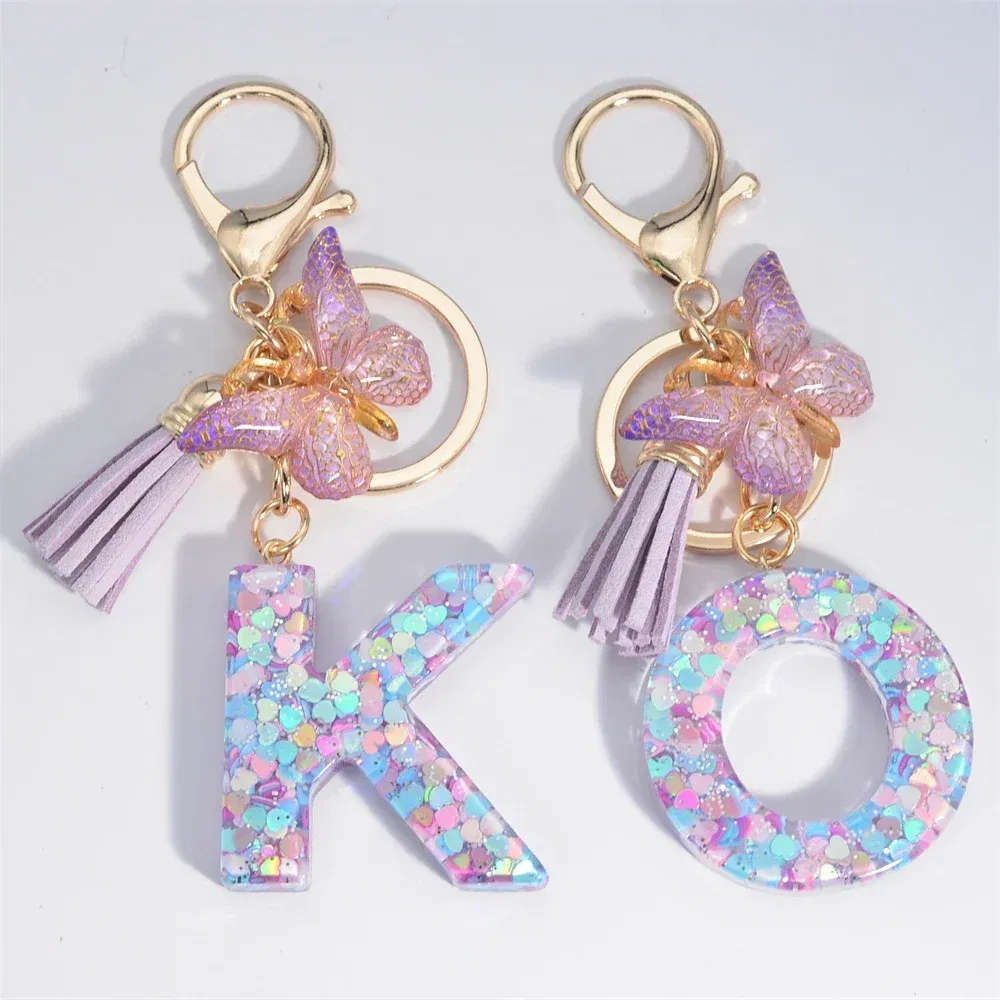 Color: PURPLE - Fashion Tassel Butterfly 26Letter Keychain Colorful Love Heart Filled Resin Alphabet Keyring Women Girls Car Bag Phone Pendant