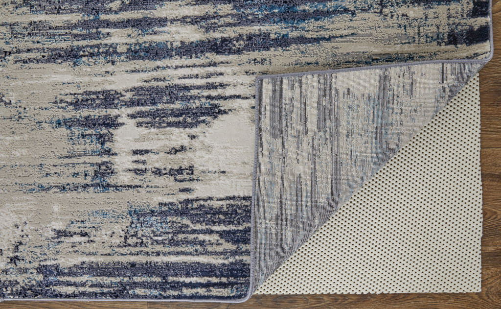 10' X 13' Tan Blue And Ivory Abstract Power Loom Distressed Area Rug